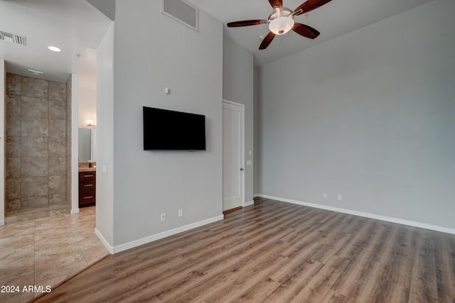 unfurnished living room featuring light hardwood / wood-style floors and ceiling fan