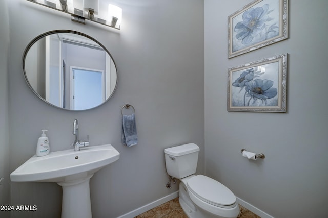 bathroom featuring tile patterned flooring and toilet