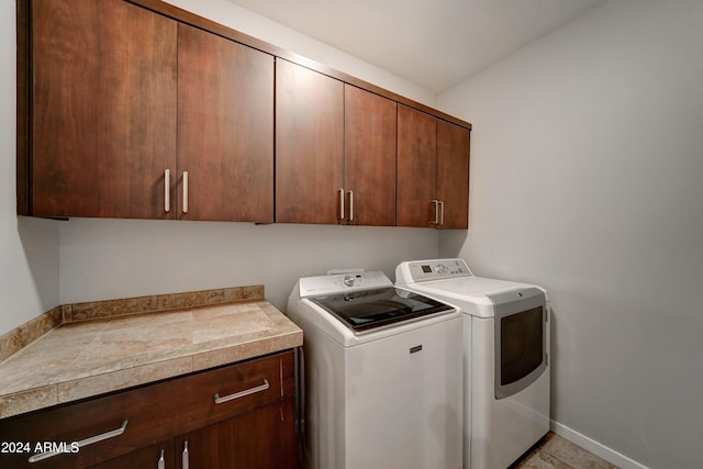 washroom with cabinets and independent washer and dryer