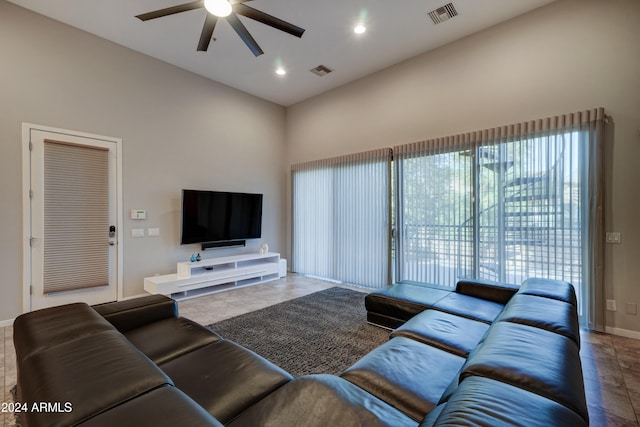 tiled living room featuring a high ceiling and ceiling fan