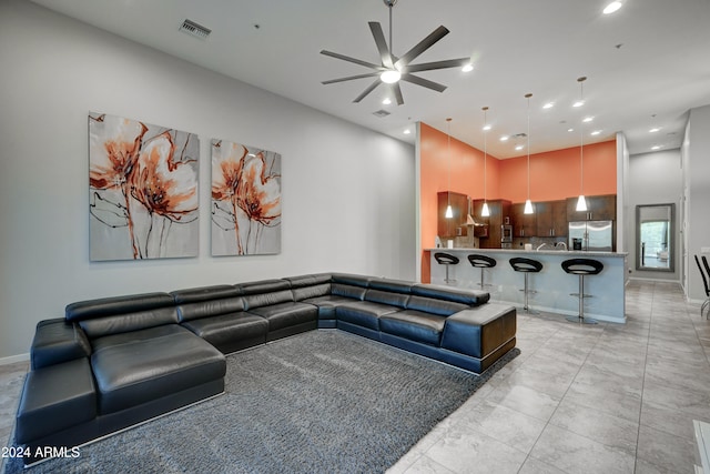 living room featuring ceiling fan and light tile patterned flooring