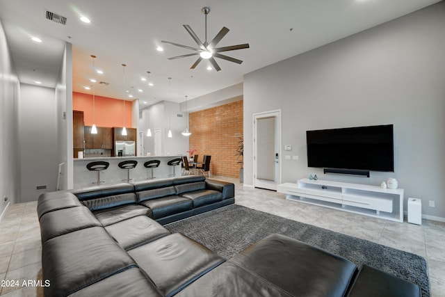 living room with ceiling fan and light tile patterned flooring