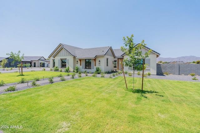 modern inspired farmhouse with a mountain view and a front lawn