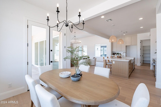 dining room with an inviting chandelier and light hardwood / wood-style floors