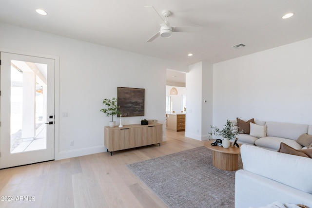 living room featuring ceiling fan and light hardwood / wood-style flooring