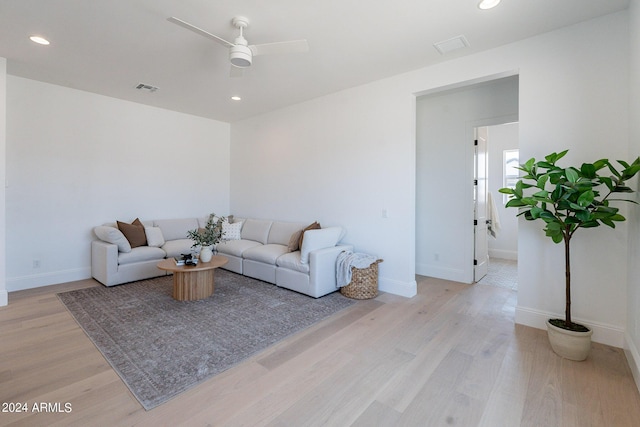 living room with ceiling fan and light hardwood / wood-style floors