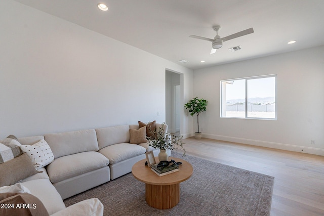 living room featuring ceiling fan and light wood-type flooring