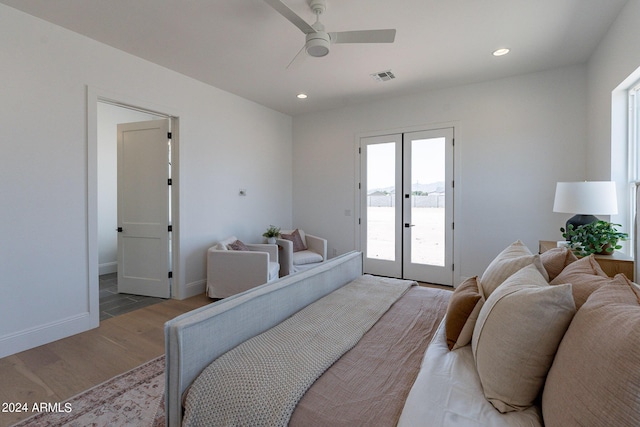 bedroom featuring light wood-type flooring, access to exterior, ceiling fan, and french doors