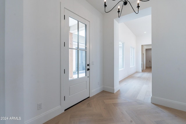 entryway featuring light parquet floors and a notable chandelier