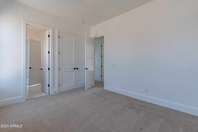 unfurnished bedroom with light carpet