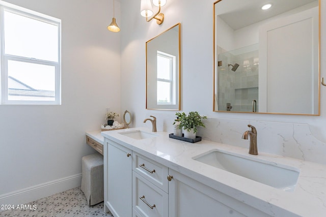 bathroom featuring a shower with door and vanity