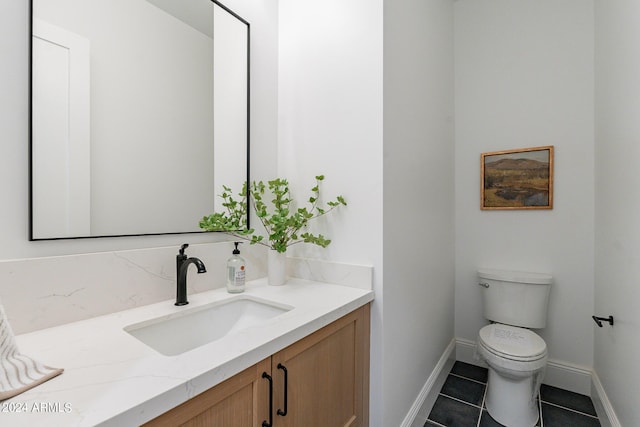 bathroom featuring vanity, toilet, and tile patterned flooring