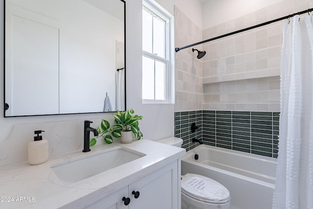 full bathroom featuring shower / tub combo, vanity, plenty of natural light, and toilet