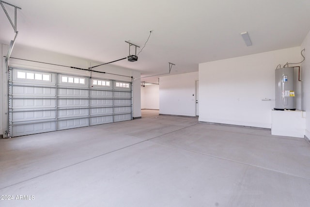 garage featuring a garage door opener and electric water heater