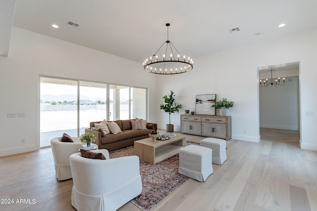 living room with a chandelier and light wood-type flooring