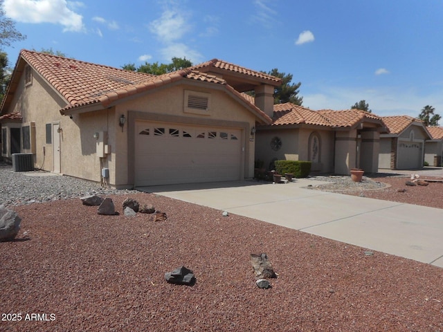 9203 W Behrend Dr, Peoria, AZ 85382 - mediterranean / spanish-style home featuring stucco siding, a garage, a tile roof, and driveway
