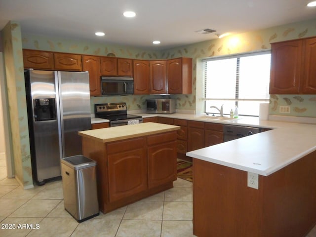 9203 W Behrend Dr, Peoria, AZ 85382 - kitchen featuring stainless steel appliances, a kitchen island, light tile patterned floors, a peninsula, and recessed lighting