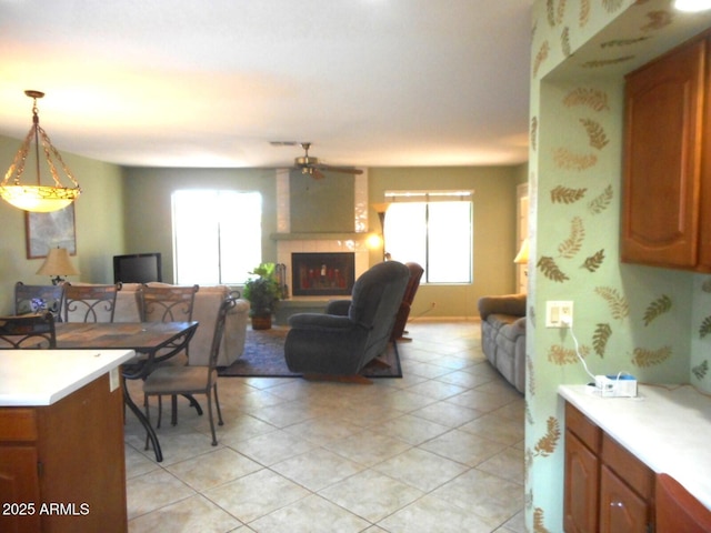 9203 W Behrend Dr, Peoria, AZ 85382 - dining area with a large fireplace, ceiling fan, and light tile patterned floors