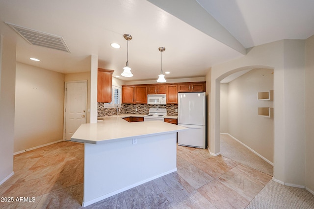 5249 E Shea Blvd Unit 215, Scottsdale, AZ 85254 - kitchen with white appliances, arched walkways, light countertops, decorative backsplash, and decorative light fixtures