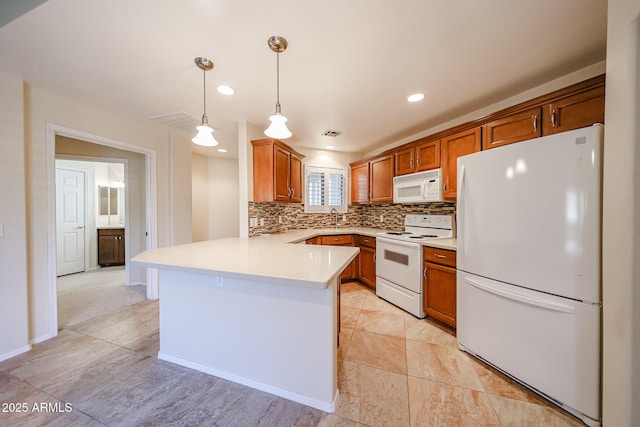 5249 E Shea Blvd Unit 215, Scottsdale, AZ 85254 - kitchen featuring white appliances, a peninsula, tasteful backsplash, light countertops, and brown cabinetry