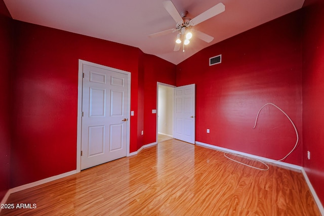 5249 E Shea Blvd Unit 215, Scottsdale, AZ 85254 - unfurnished bedroom with light wood finished floors, vaulted ceiling, and a ceiling fan
