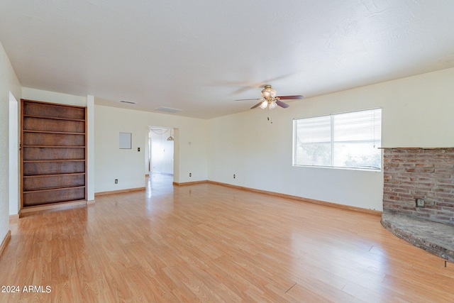 unfurnished living room with ceiling fan and light hardwood / wood-style floors