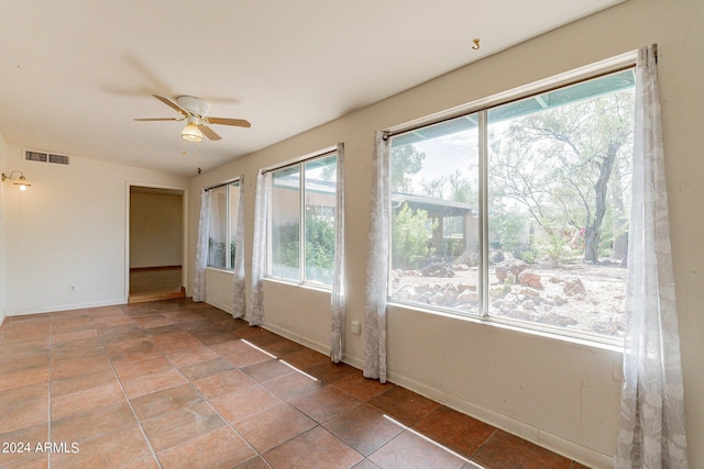 interior space featuring a wealth of natural light, ceiling fan, and tile patterned floors