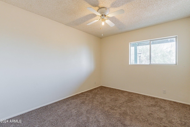 spare room with a textured ceiling, ceiling fan, and carpet floors