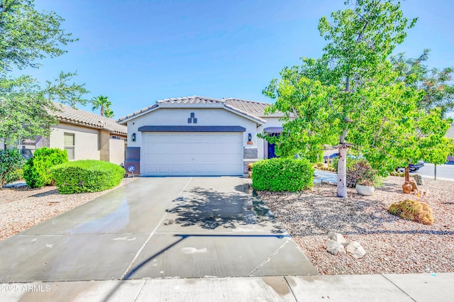46068 W Guilder Ave, Maricopa, AZ 85139 - view of front facade featuring stucco siding, an attached garage, driveway, and a tile roof