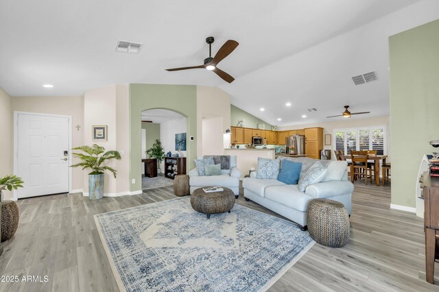 46068 W Guilder Ave, Maricopa, AZ 85139 - living room featuring a ceiling fan, arched walkways, recessed lighting, light wood finished floors, and lofted ceiling