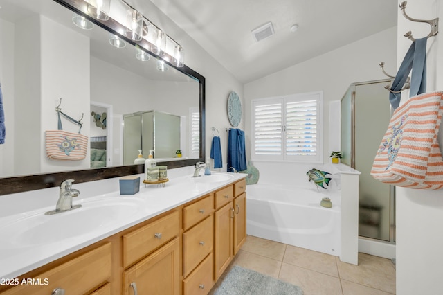 46068 W Guilder Ave, Maricopa, AZ 85139 - full bathroom with lofted ceiling, a shower stall, a bath, double vanity, and tile patterned flooring