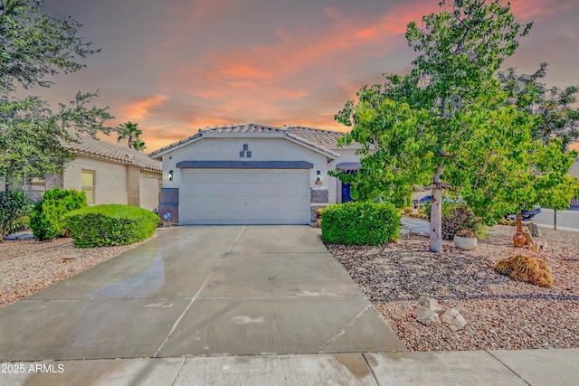 46068 W Guilder Ave, Maricopa, AZ 85139 - view of front of home featuring stucco siding, driveway, a garage, and a tile roof