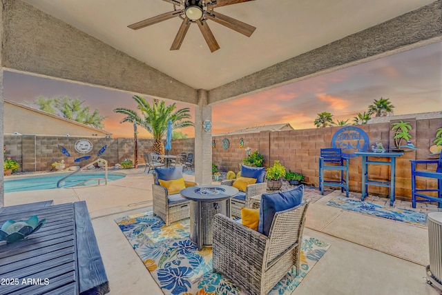 46068 W Guilder Ave, Maricopa, AZ 85139 - patio terrace at dusk with a fenced backyard, a ceiling fan, a patio, and an outdoor fire pit