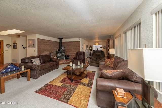 1147 Pedro Ct, Rio Rico, AZ 85648 - carpeted living room featuring a textured ceiling and a wood stove