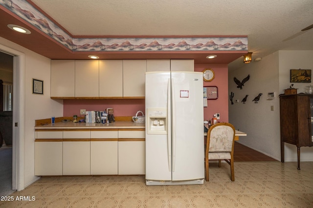 1147 Pedro Ct, Rio Rico, AZ 85648 - kitchen featuring white refrigerator with ice dispenser, light countertops, recessed lighting, and cream cabinetry