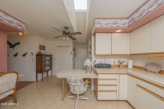 1147 Pedro Ct, Rio Rico, AZ 85648 - kitchen with light flooring, light countertops, ceiling fan, and white cabinetry