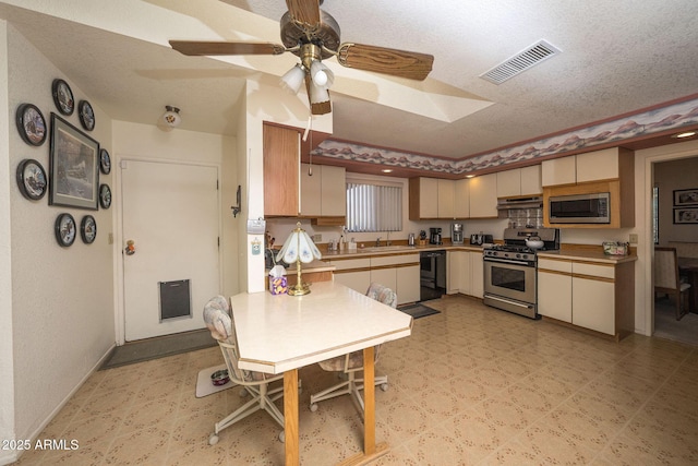 1147 Pedro Ct, Rio Rico, AZ 85648 - kitchen with stainless steel appliances, under cabinet range hood, light floors, a textured ceiling, and ceiling fan