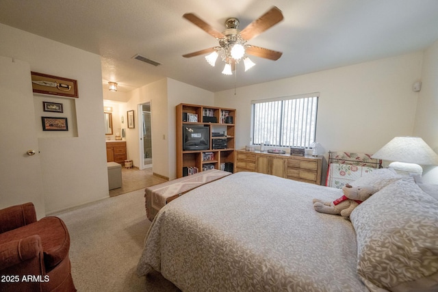 1147 Pedro Ct, Rio Rico, AZ 85648 - bedroom featuring light colored carpet, connected bathroom, and ceiling fan