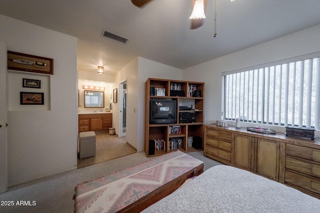1147 Pedro Ct, Rio Rico, AZ 85648 - bedroom with connected bathroom and light colored carpet