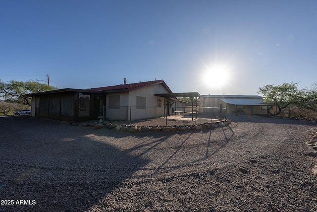 1147 Pedro Ct, Rio Rico, AZ 85648 - rear view of property featuring a sunroom and a patio area