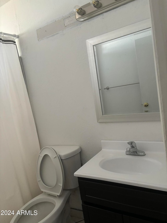 bathroom featuring vanity and toilet