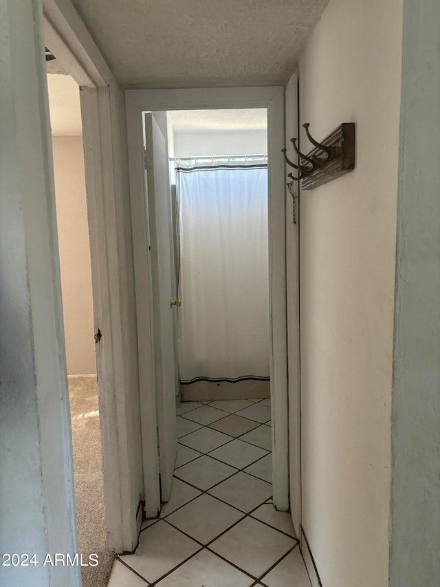 hallway featuring light tile patterned floors