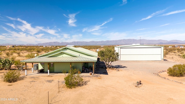 view of front facade with a mountain view, an outbuilding, and a garage