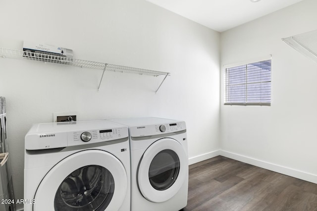 clothes washing area featuring dark wood-type flooring and washing machine and dryer