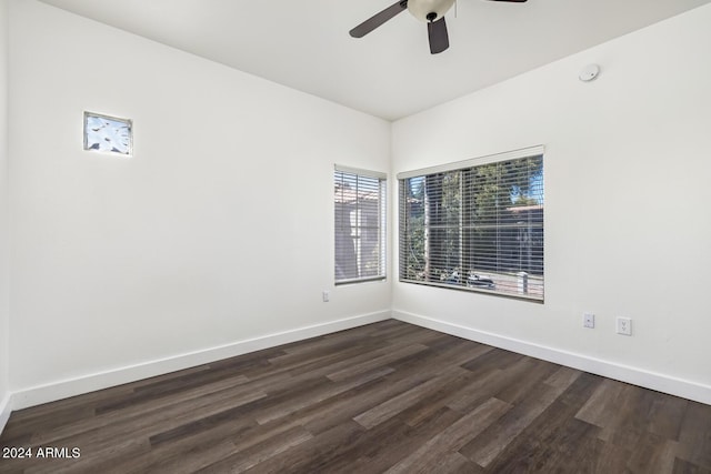 empty room featuring dark wood-type flooring and ceiling fan