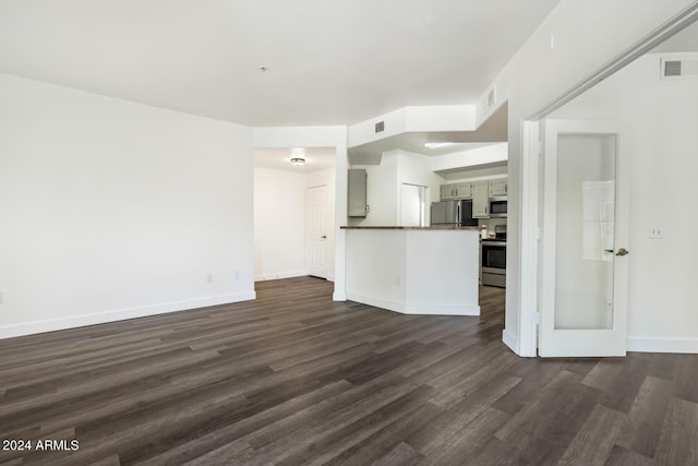 unfurnished living room featuring dark wood-type flooring