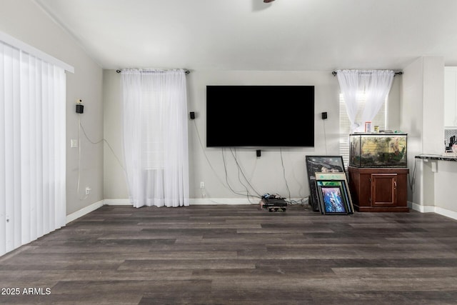 36480 W El Greco St, Maricopa, AZ 85138 - unfurnished living room featuring a wealth of natural light, wood finished floors, and baseboards