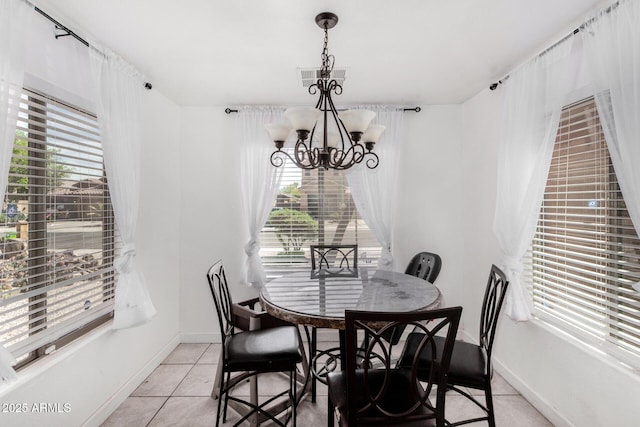 36480 W El Greco St, Maricopa, AZ 85138 - dining area featuring baseboards, visible vents, a notable chandelier, and light tile patterned flooring