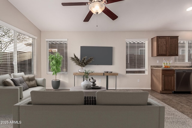 tiled living room with ceiling fan and lofted ceiling