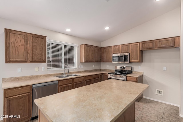 kitchen with sink, stainless steel appliances, a kitchen island, vaulted ceiling, and light tile patterned flooring